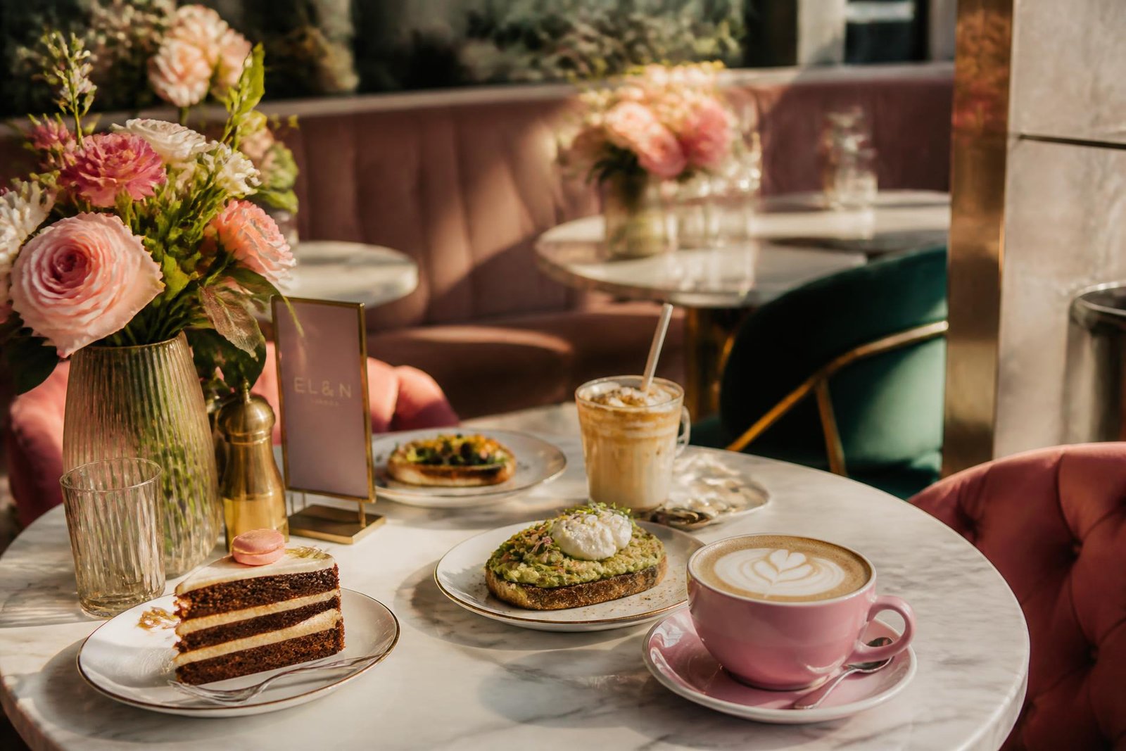 Marble table with latte, cake and brunch inside Lucy's Cafe & Bistro